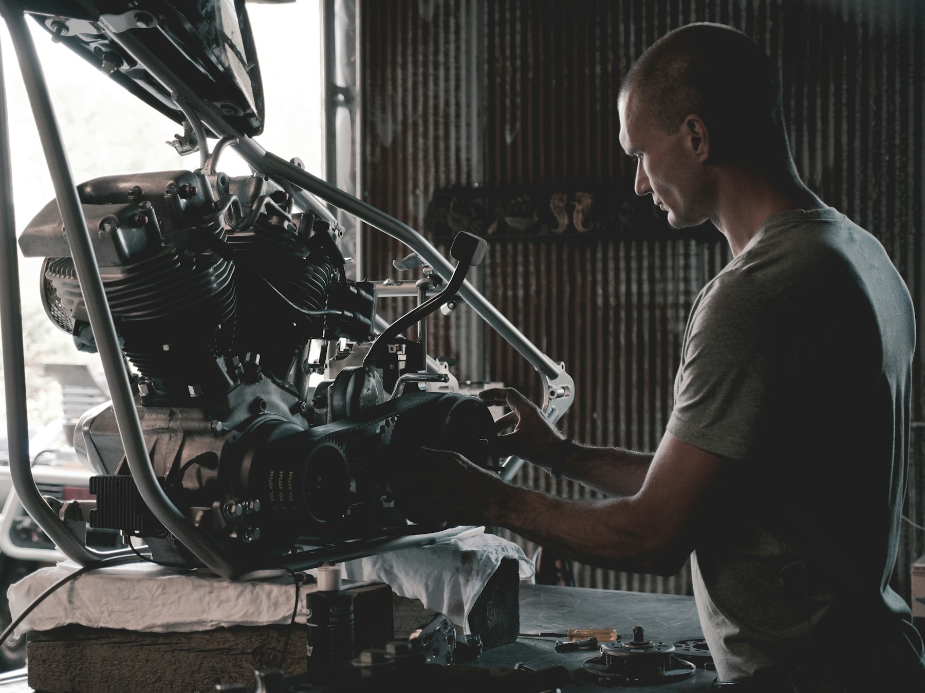 Motorcycle engine work at a garage workbench